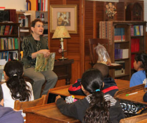 Read Across Monrovia event, a woman reading to children in a classroom.