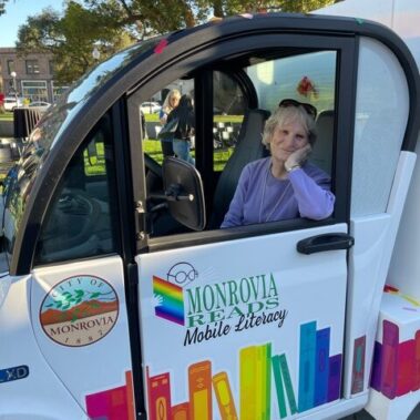 Joanne Spring sitting in the driver seat of the van.