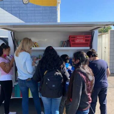 Kids checking out the books on the van
