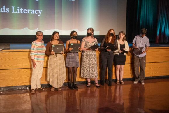 Winners of the Monrovia Read Scholarship standing in front of the stage