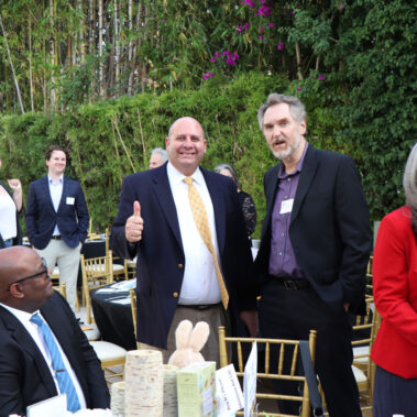 Two posing for picture and giving a thumbs up