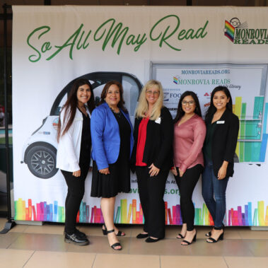 The staff of Foothill Credit Union posing in front of banner