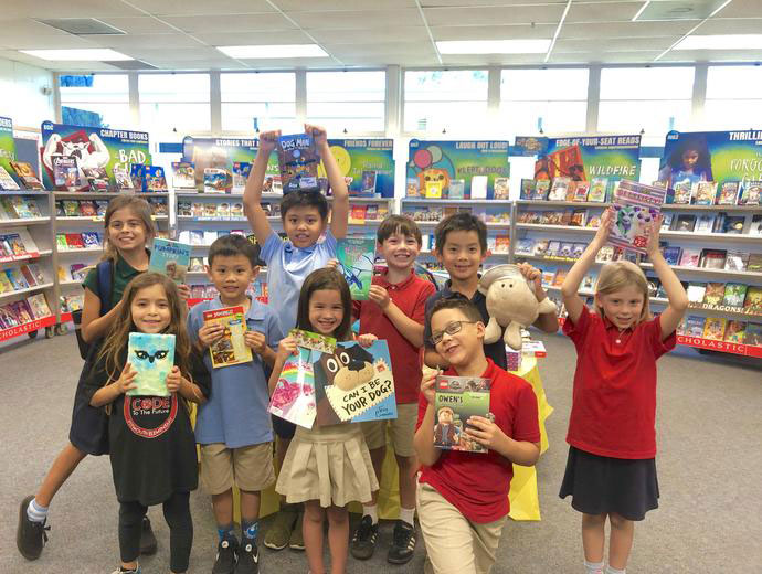 Group picture of kids at Plymouth Elementary School holding up books