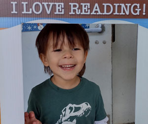 Cute young boy smiling through a window