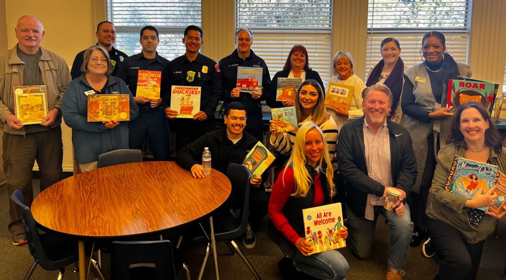 Group picture of adult readers holding books