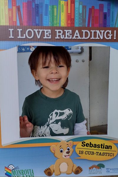 Cute young boy smiling through a window