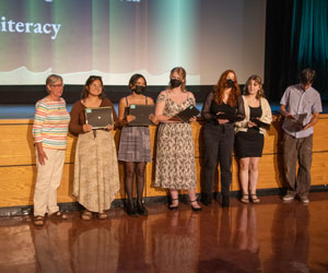 Winners of the Monrovia Read Scholarship standing in front of the stage