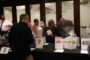 People checking out the auction table at the So All May Read fundraiser.