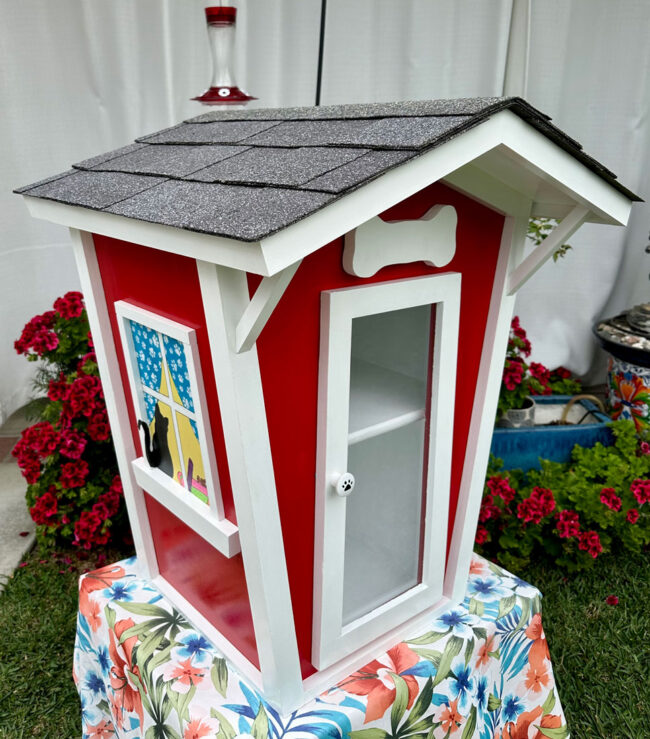 Little-Library-pic-1 Little Library that looks like a doll house colored in red and white.