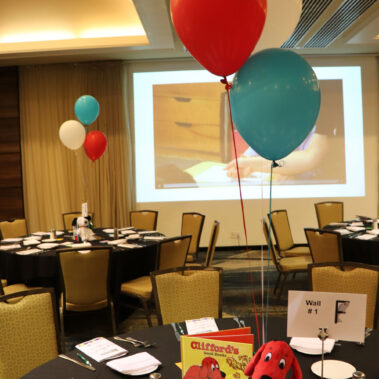 Table set up with Clifford the dog book and balloons.