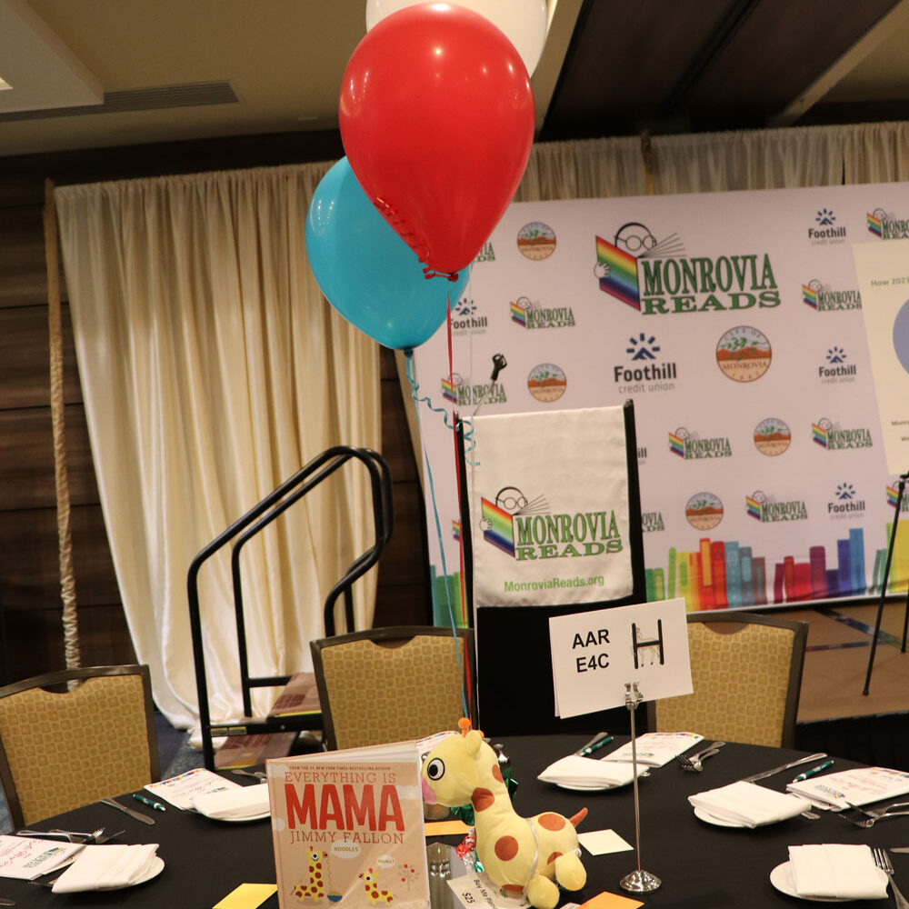 Table set up with book and balloons.