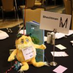 Table set up with a yellow stuffed animal from a book.